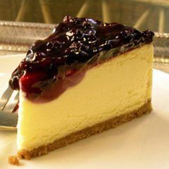 Blueberry topping on cheese cake slice